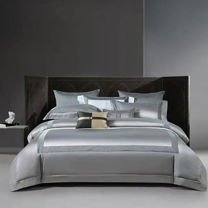 Silver satin bedding set with subtle geometric embroidery and coordinating pillows for decorbites king size luxury bedroom