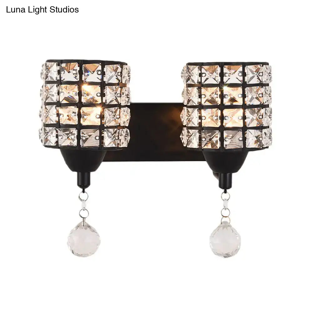 Modern style black wall sconce with two crystal shade cylinders and dangling teardrop crystals 110v-120v light fixture
