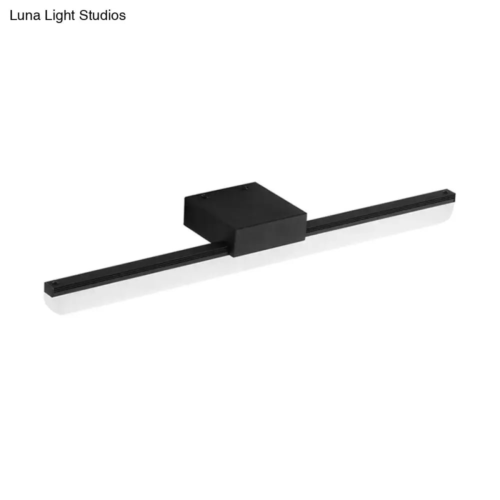 Modern style black matte wall light with rectangular central housing providing white light for bedroom use
