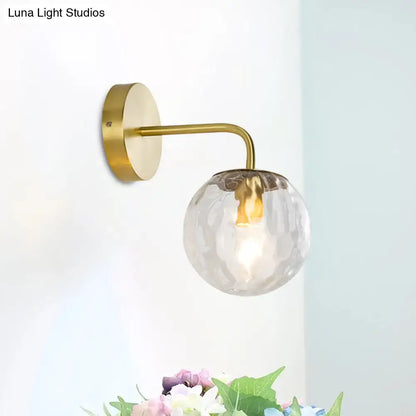 Modern style gold color wall sconce with hammered clear textured glass globe for living room lighting