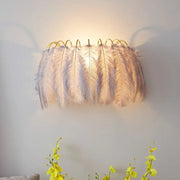 Modern style grey white sconce light with soft white feathers and curved golden frame for parlor wall decor