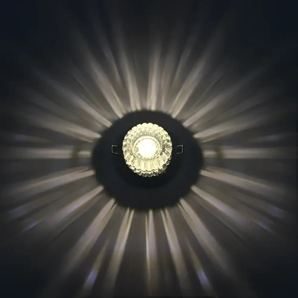 Modern sunburst crystal led flush mount ceiling light with faceted crystal center emitting warm white illumination