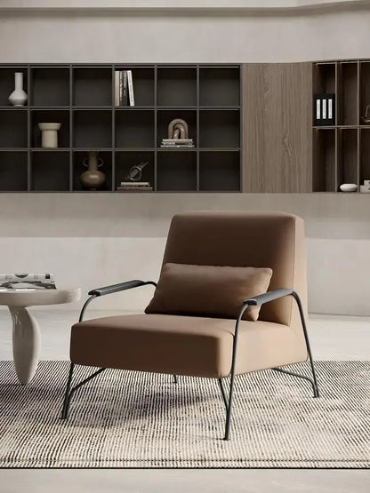 Modern taupe italian style single sofa chair in beige upholstered fabric with sleek black metal frame and matching cushion
