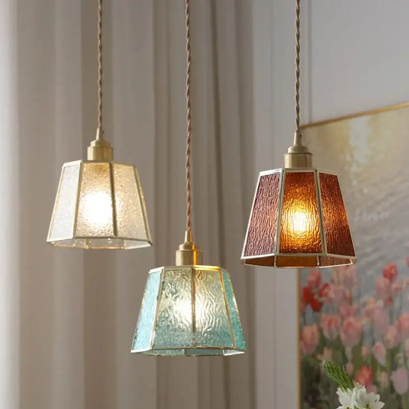 Three hanging decorbites copper glass led pendant lamps with amber teal and frosted white textured glass shades for dining room decor