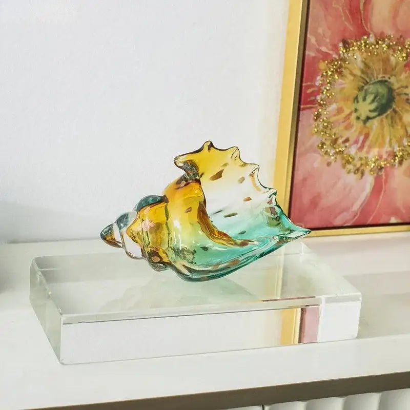 Modern teal and amber glass conch shell statue made of translucent hand-blown glass for living room decor