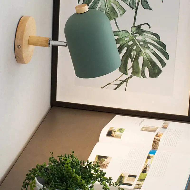 Modern teal wall lamp with matte finish wooden base and handle designed as a bedroom sconce