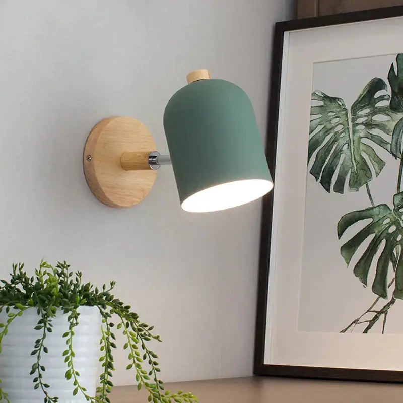 Modern teal and wood wall lamp with matte finish and natural wood base designed as a bedroom sconce
