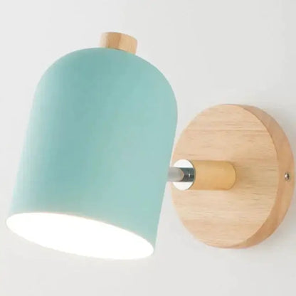 Minimalist wall lamp with a soft teal ceramic shade and natural wood accents for modern bedroom sconce lighting