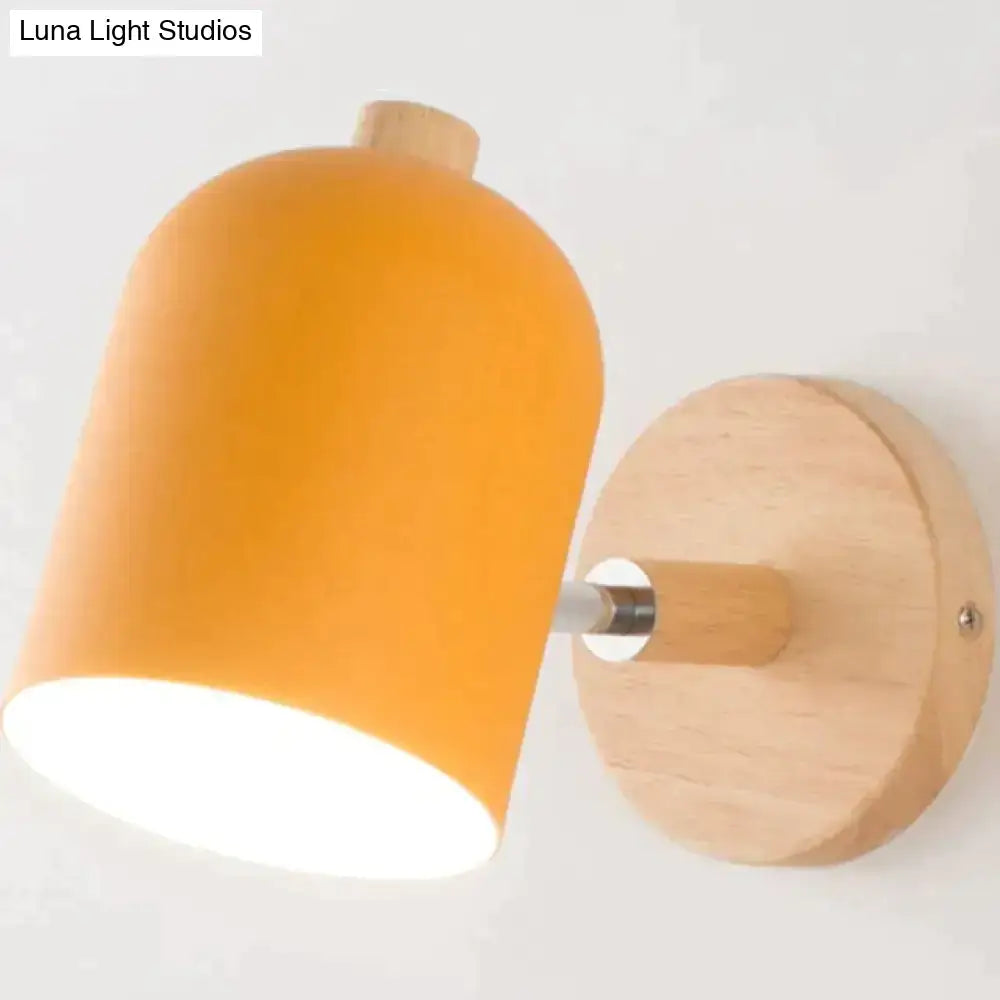 Modern teal and wood wall lamp with warm orange cylindrical lampshade mounted on light wood circular plate