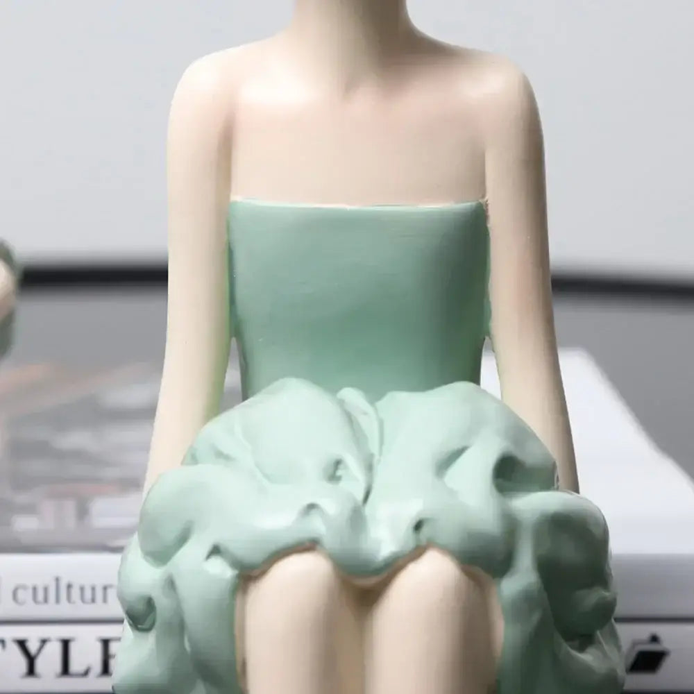 A delicate mint-green ceramic bowknot girl figurine in a strapless dress with a voluminous sculpted skirt for living room decor
