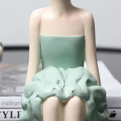 A delicate mint-green ceramic bowknot girl figurine in a strapless dress with a voluminous sculpted skirt for living room decor