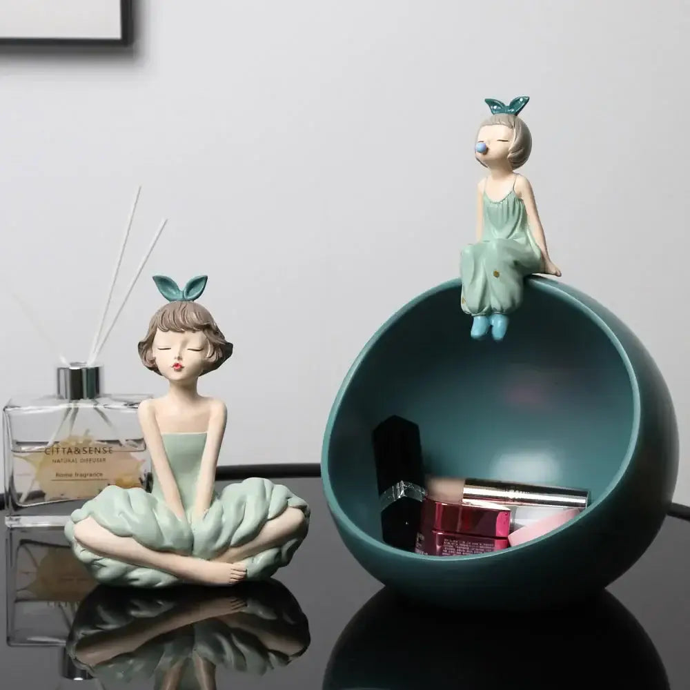 Modern teal resin storage bowl with seated bowknot girl figurine perched on rim for living room decor