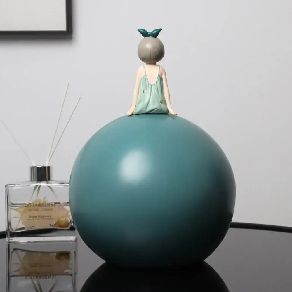 Modern teal bowknot girl figurine in mint-green dress with gold dots sitting on a matte teal sphere for living room decor
