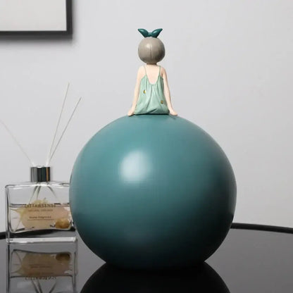 Modern teal bowknot girl figurine in mint-green dress with gold dots sitting on a matte teal sphere for living room decor