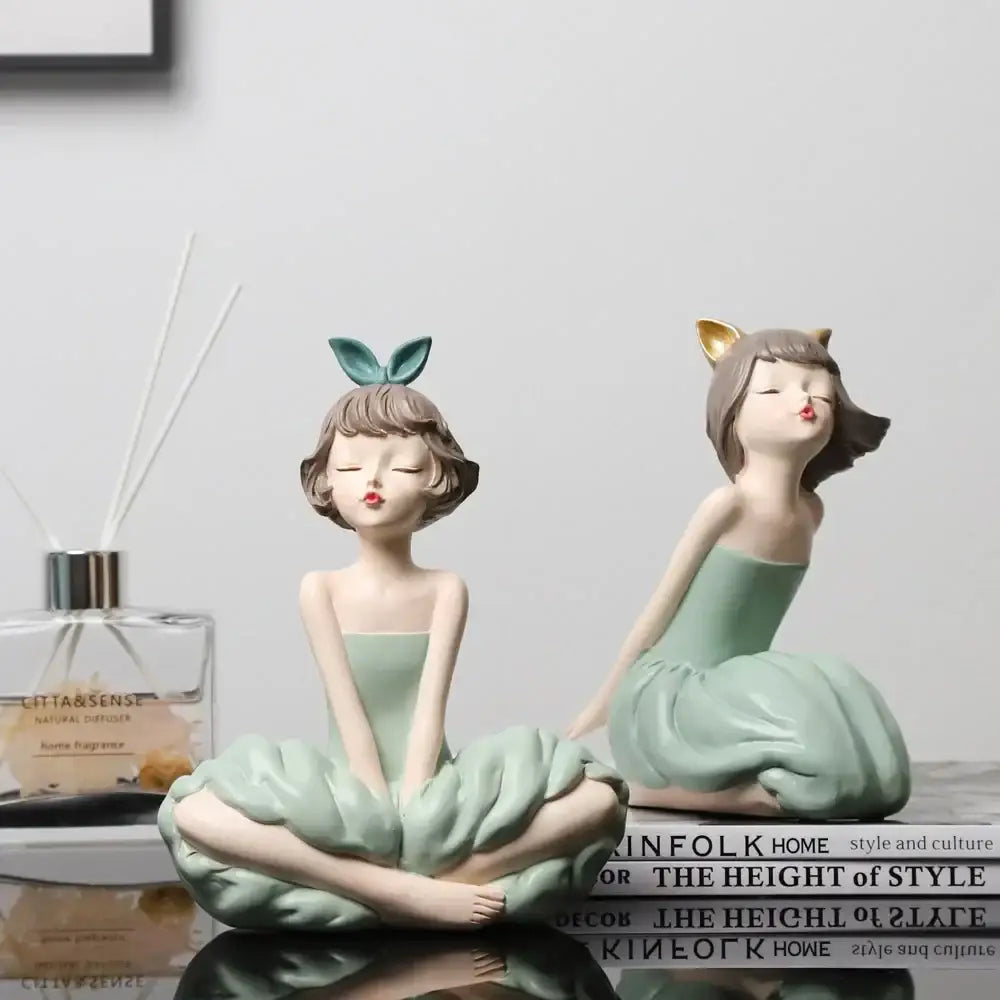 Two mint-green resin bowknot girl figurines with bunny and cat ears in ballet poses for living room decor