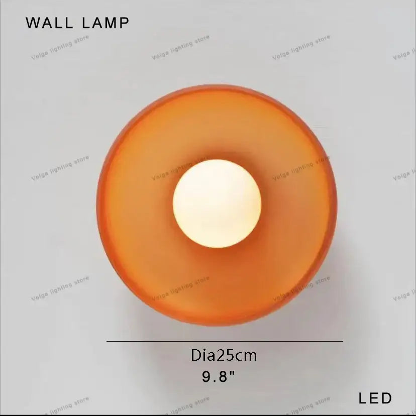 Orange translucent circular wall lamp with central led light source complementing decorbites designer mushroom floor lamp