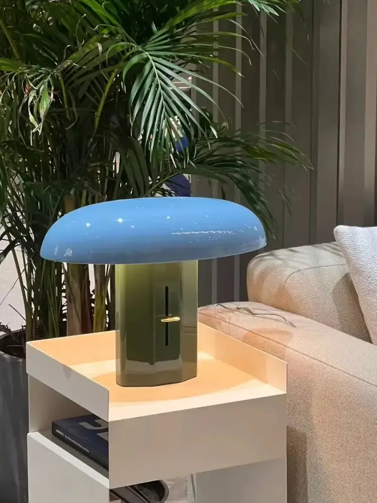 A designer mushroom floor lamp with a glossy light blue shade and olive green cylindrical base for modern decorbites decor