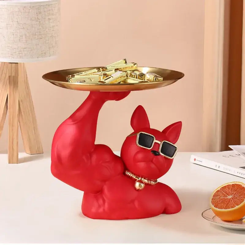 Red decorbites bulldog tray figurine with muscular arm holding gold tray wearing black sunglasses and golden bell collar