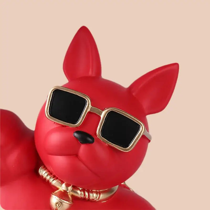 Red glossy stylized dog figurine with gold sunglasses and bell collar on decorbites bulldog tray for modern living room decor