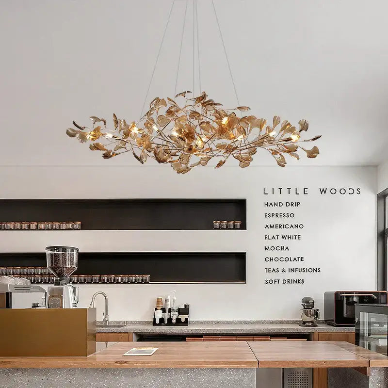 Modern teal glass gingko leaf chandelier featuring golden leaf-shaped design by decorbites for dining room decorbites gingko leaf