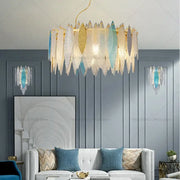 Modern teal and gold glass chandelier light featuring cascading translucent leaf-shaped glass shades for living room