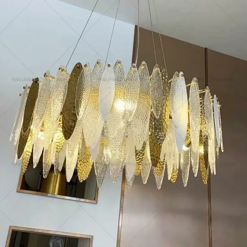 Modern teal and gold glass chandelier light with textured glass leaf design for elegant living room lighting