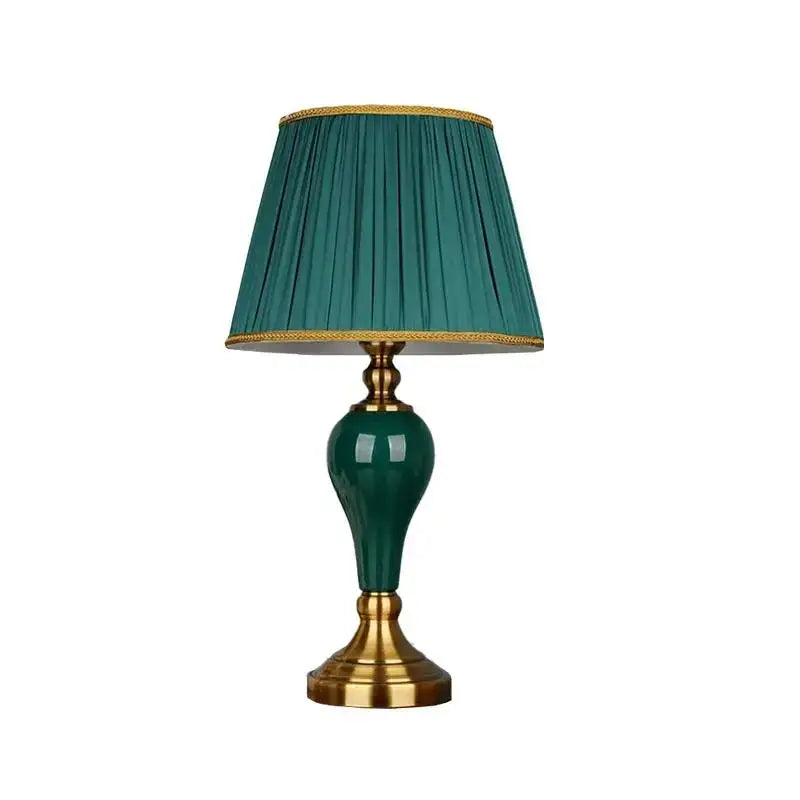 Elegant modern teal green ceramic table lamp with gold-toned brass accents and pleated fabric shade for bedroom and living room