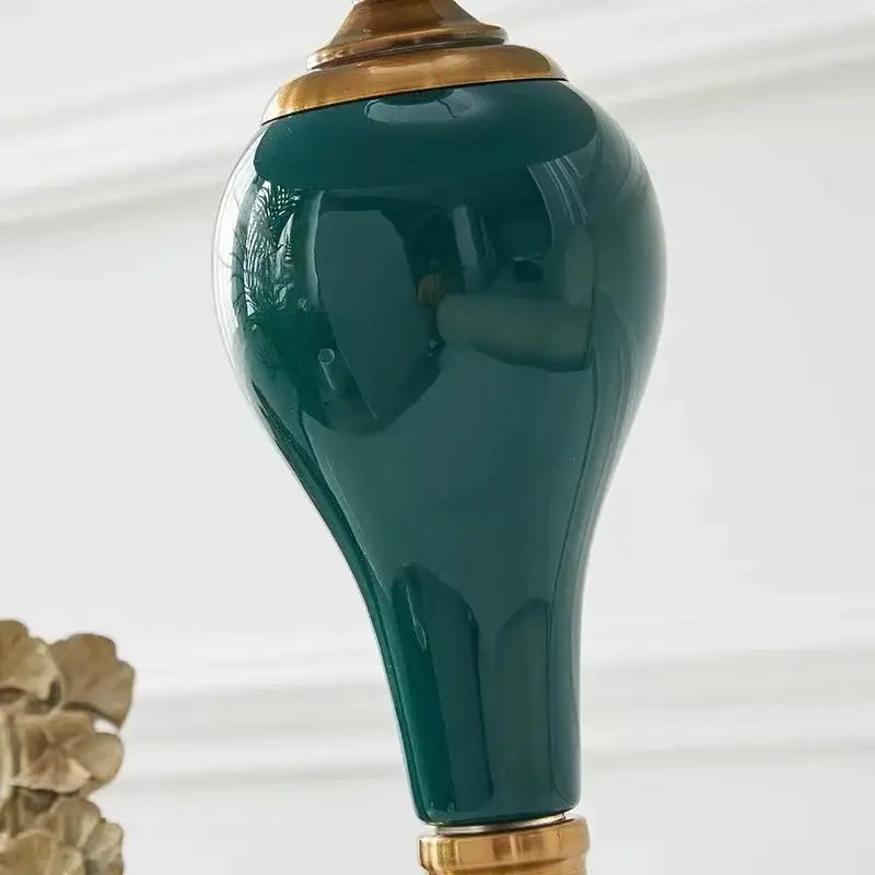 Modern teal green ceramic table lamp with deep teal ceramic lampshade and gold toned metal accents for bedroom and living room