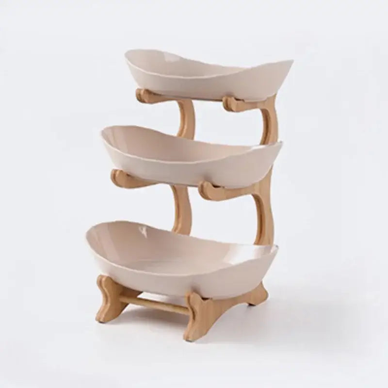 Three-tiered modern teal and white ceramic layer table plates with light wood frame for dining room fruit display