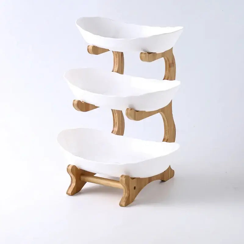 Modern teal and white ceramic layer table plates in a three-tiered white ceramic bowl stand with bamboo frame for dining use
