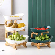 Two tiered light wood fruit stands with modern teal and white ceramic layer table plates for dining room use
