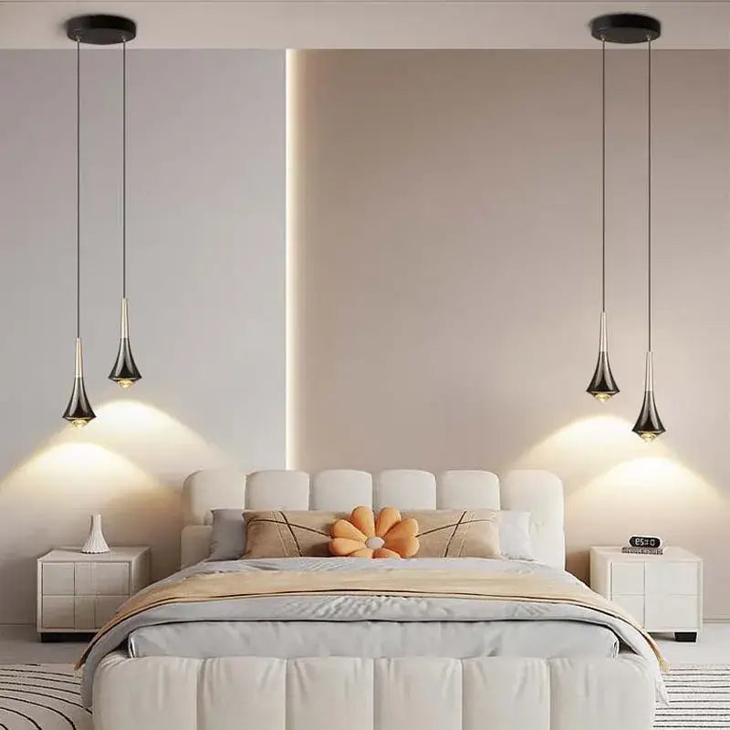 Modern black and gold cord pendant light with sleek teardrop fixtures hanging symmetrically above bed for dining room use