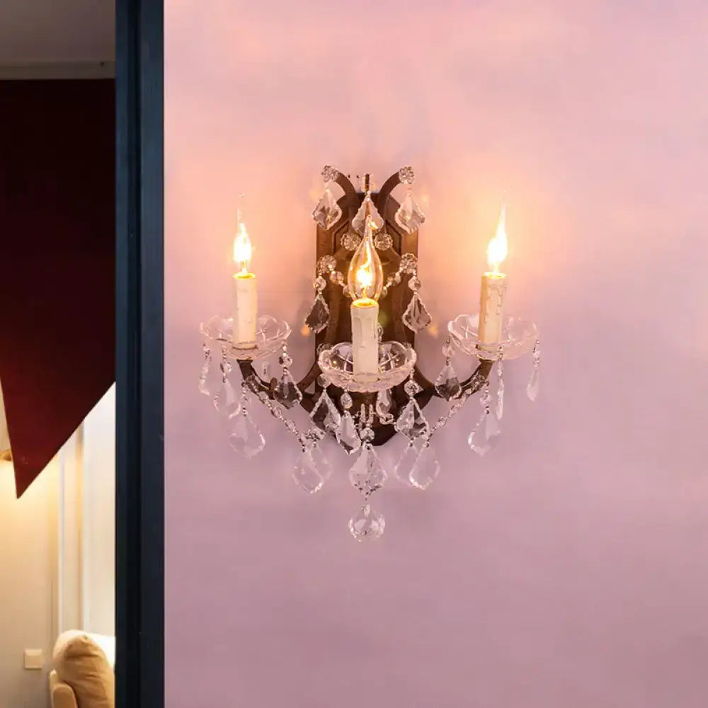 Antique-style crystal chandelier with three candle-like bulbs and ornate metalwork as modern teardrop wall lamp for living room