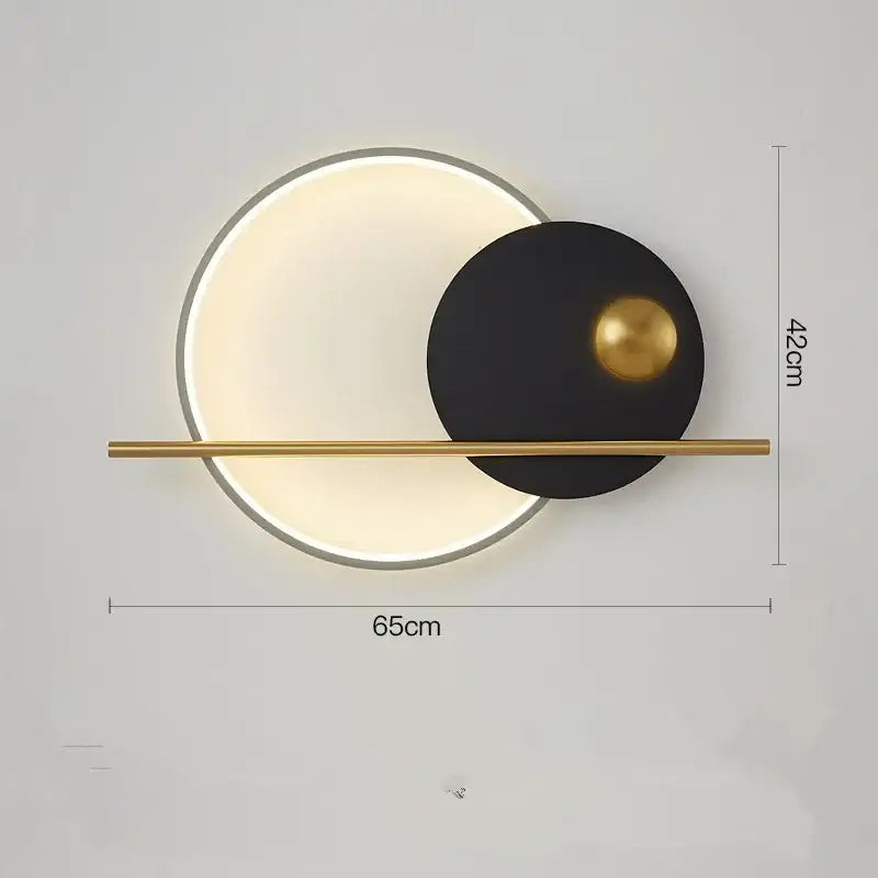 Modern luxury wall lamp with frosted glass diffuser, matte black disc, gold sphere, and brass bar for bedroom use
