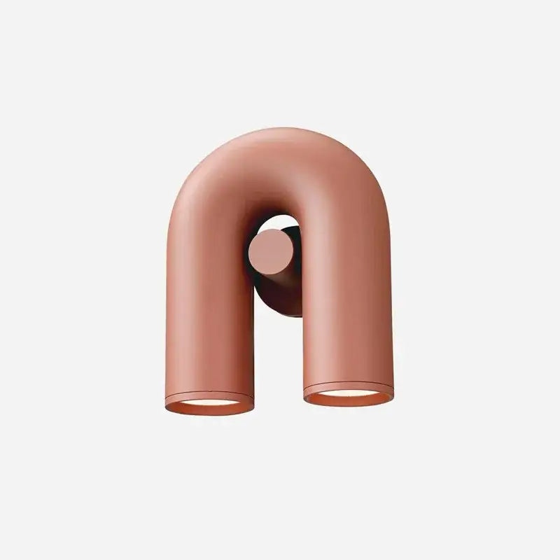 Copper-colored led u-shaped wall lamp in sleek minimalist design for modern terracotta and gray ceramic bedroom decor