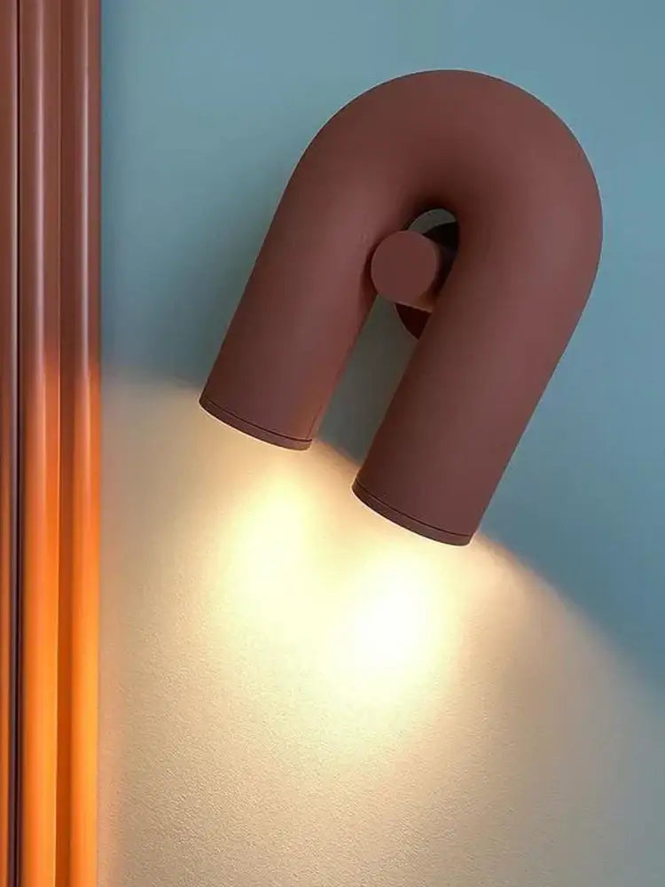 A sleek matte terracotta led u-shaped wall lamp with minimalist design for modern living room lighting