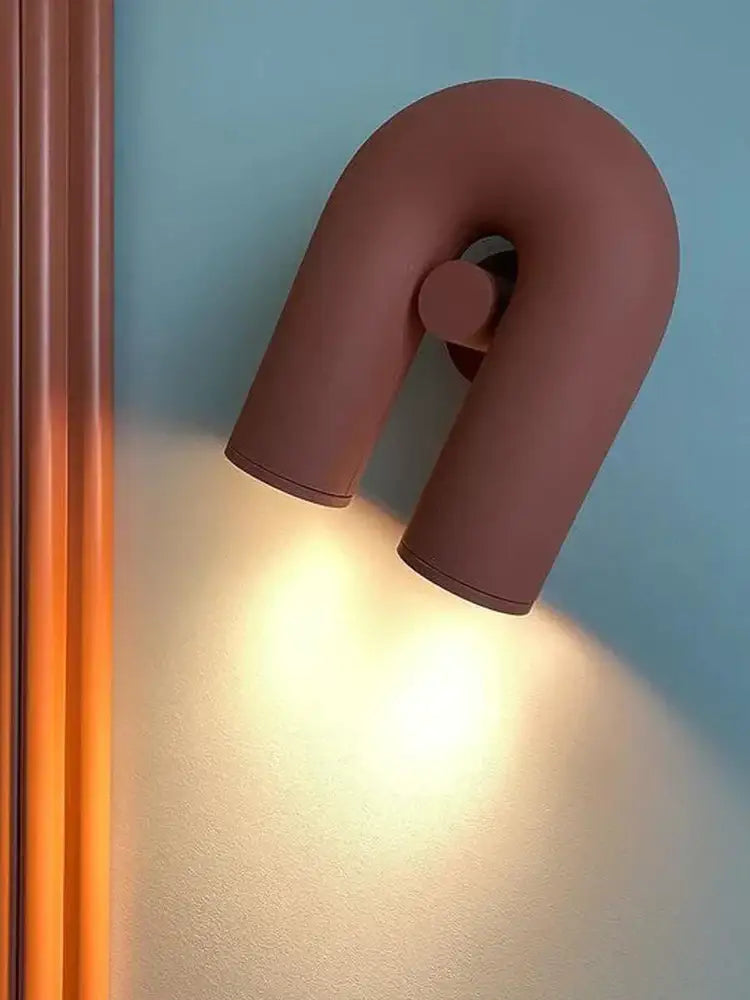 A sleek matte terracotta led u-shaped wall lamp with minimalist design for living room staircase lighting
