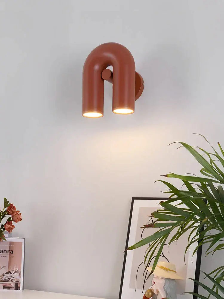 Modern terracotta led u-shaped wall lamp with two illuminated cylindrical arms for living room or staircase lighting