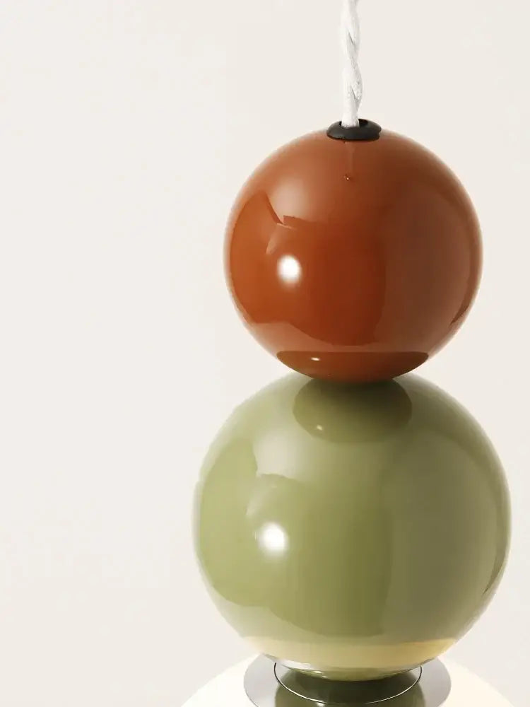 A modern pendant light with two stacked terracotta and sage green glass spheres for living room decorbites colorful ball