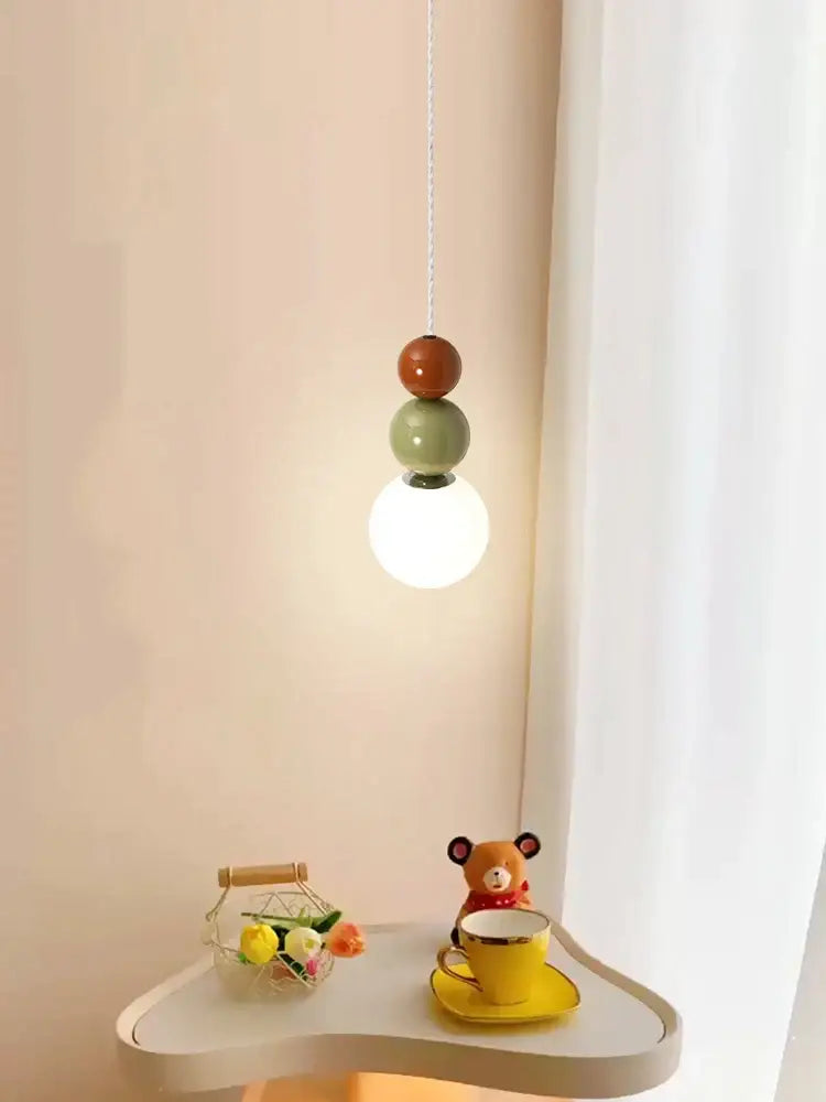 Modern pendant lights with terracotta and sage green ceramic spheres and a white glass globe for living room decorbites colorful ball glass
