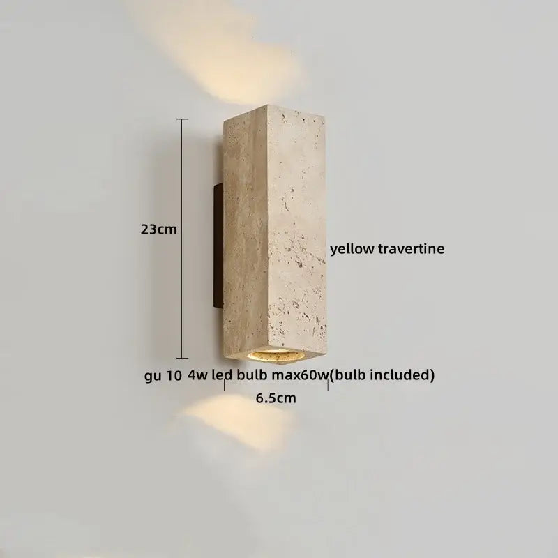 A rectangular yellow travertine led wall sconce with a textured stone finish emitting warm light for modern decorbites decor