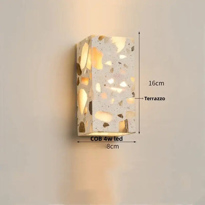 Modern terrazzo cube led wall light fixture featuring a rectangular speckled light gray and gold-toned stone pattern wall light fixture
