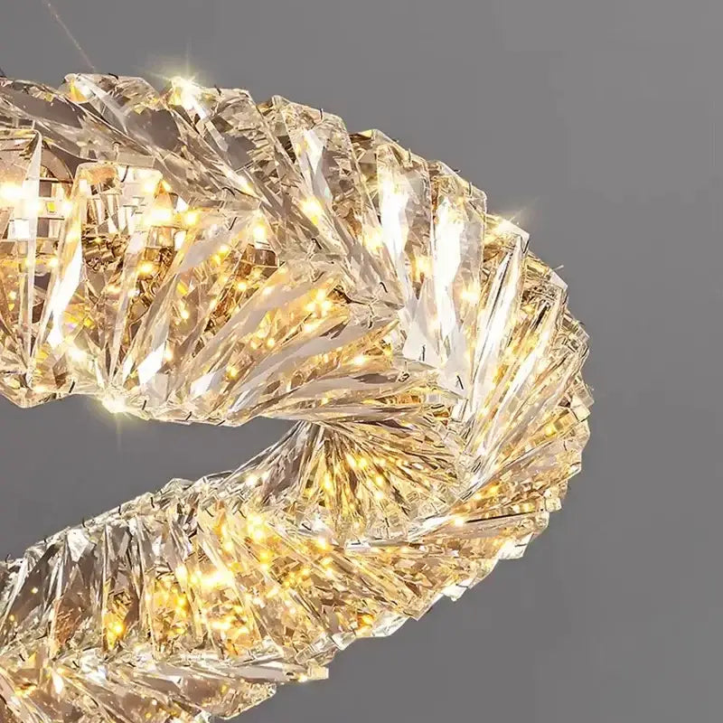 A sparkling gold-toned decorbites crystal led pendant light with twisted spiral design for warm dining room illumination