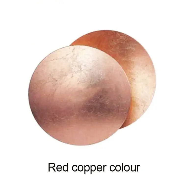 Modern textured eclipse round wall lamp with red copper overlapping discs and a tarnished metallic surface for bedroom