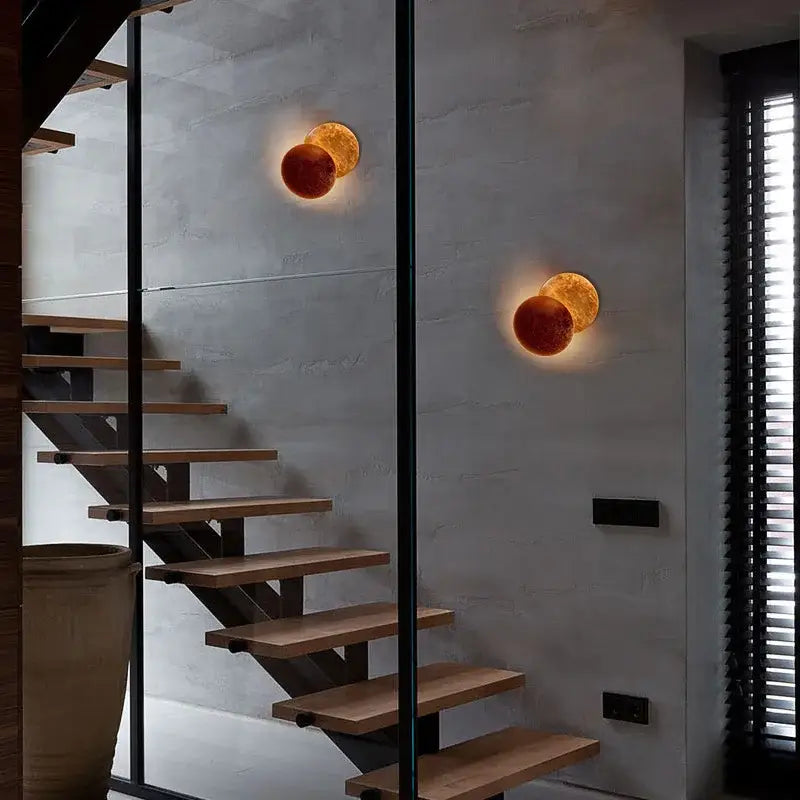 Modern textured eclipse round wall lamp in warm amber gold with spherical design for bedroom use wall lamp