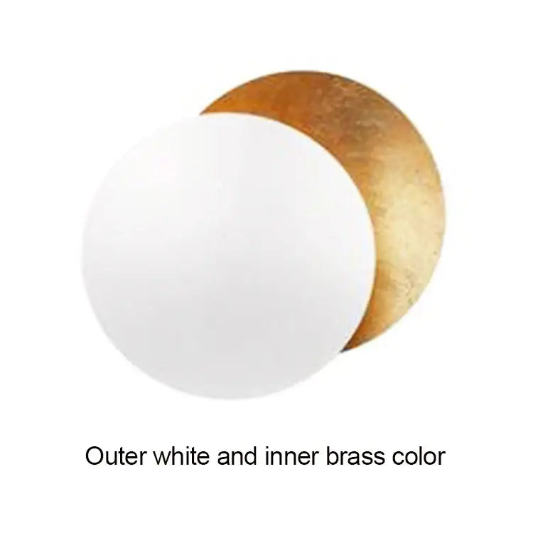 Modern textured eclipse round wall lamp featuring white and brass-colored circular discs for bedroom use