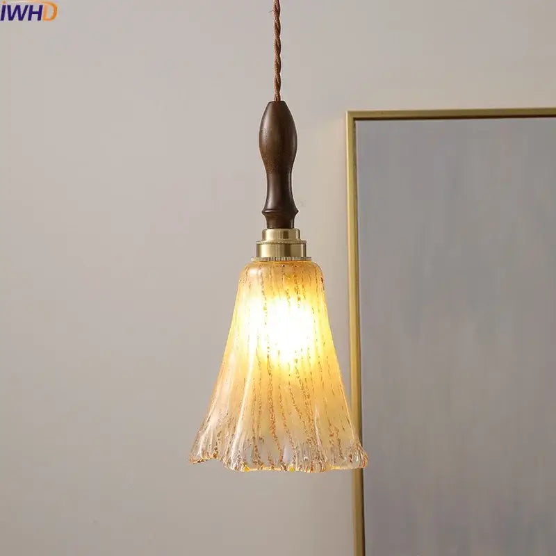 Modern textured glass copper led pendant light with warm tones dark wood handle and brass accents for kitchen dining room