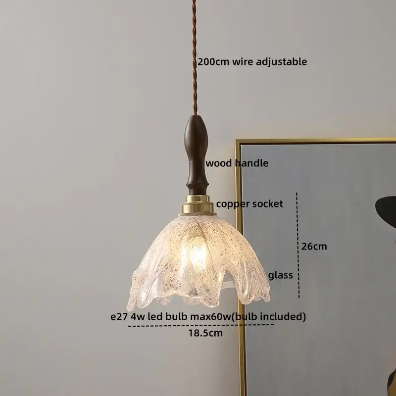 Modern textured glass copper led pendant light featuring a translucent petal design with a dark wood handle for kitchens