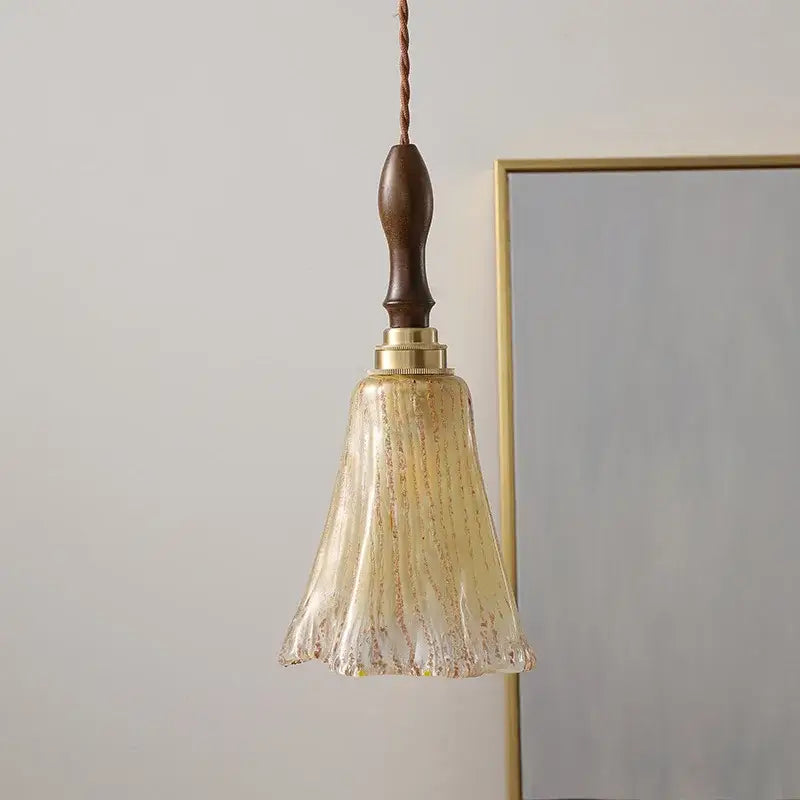 Modern pendant lights with a vintage dark wood handle, brass hardware, and textured amber glass copper led shade