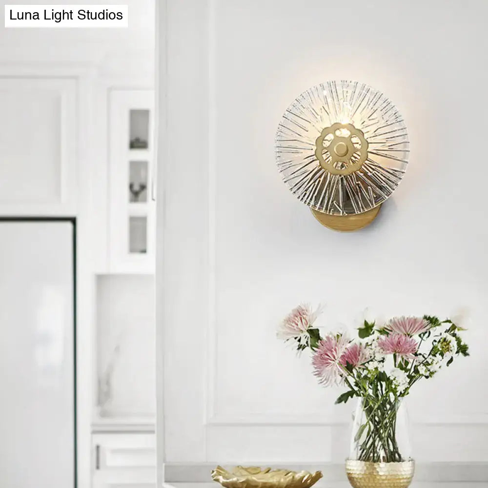 Modern textured gold wall lamp with sunburst design and clear crystal glass prisms for bedroom lighting